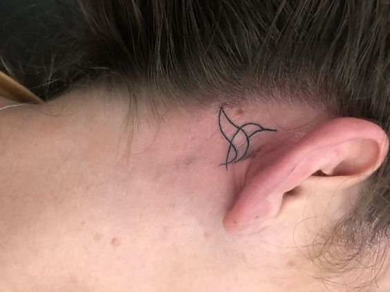 tatouage Oiseau en une seule ligne derriere l'oreille
