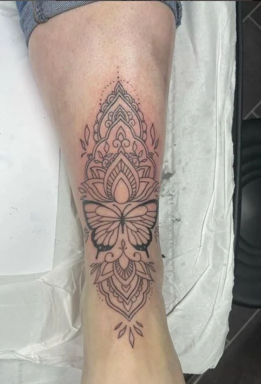 Tatouage Papillon Entre Mandalas Sur Le Pied