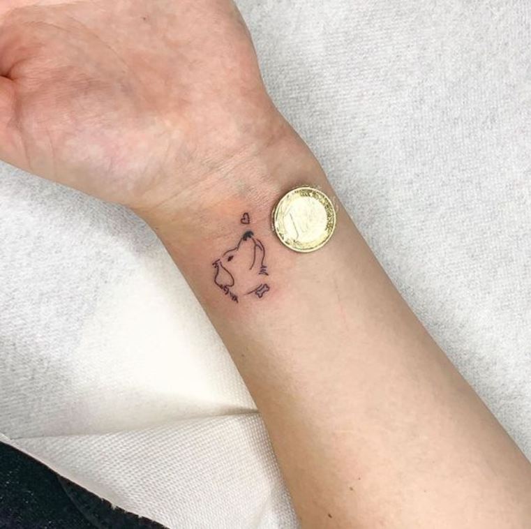 Tatouage Tête De Chien Minimaliste Sur Le Poignet 